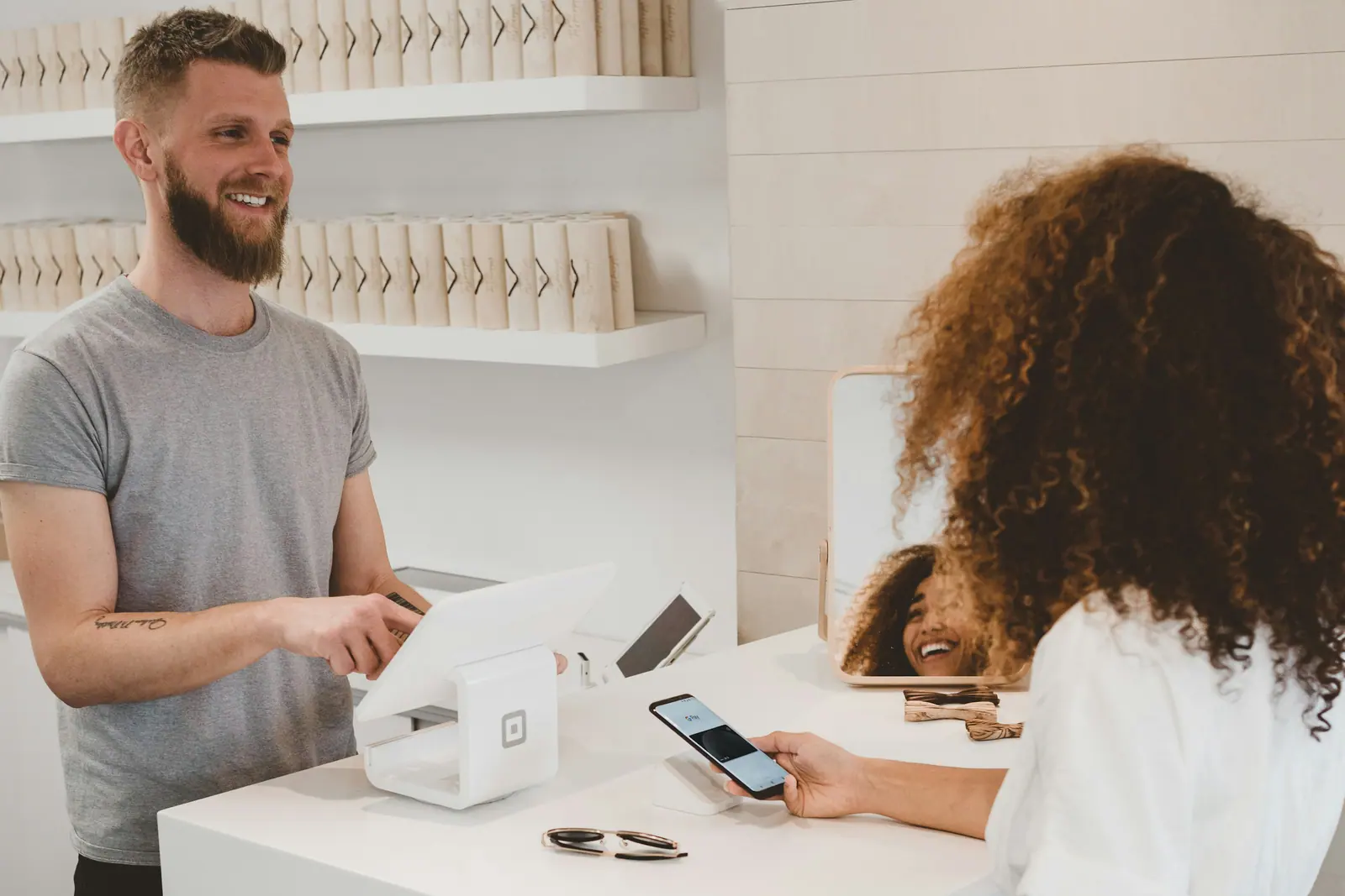 Shop owner helping a customer at the front counter